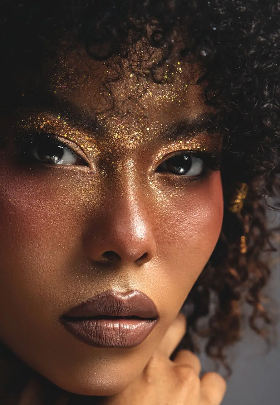 Stunning close-up of a woman with glittery makeup and curly hair.