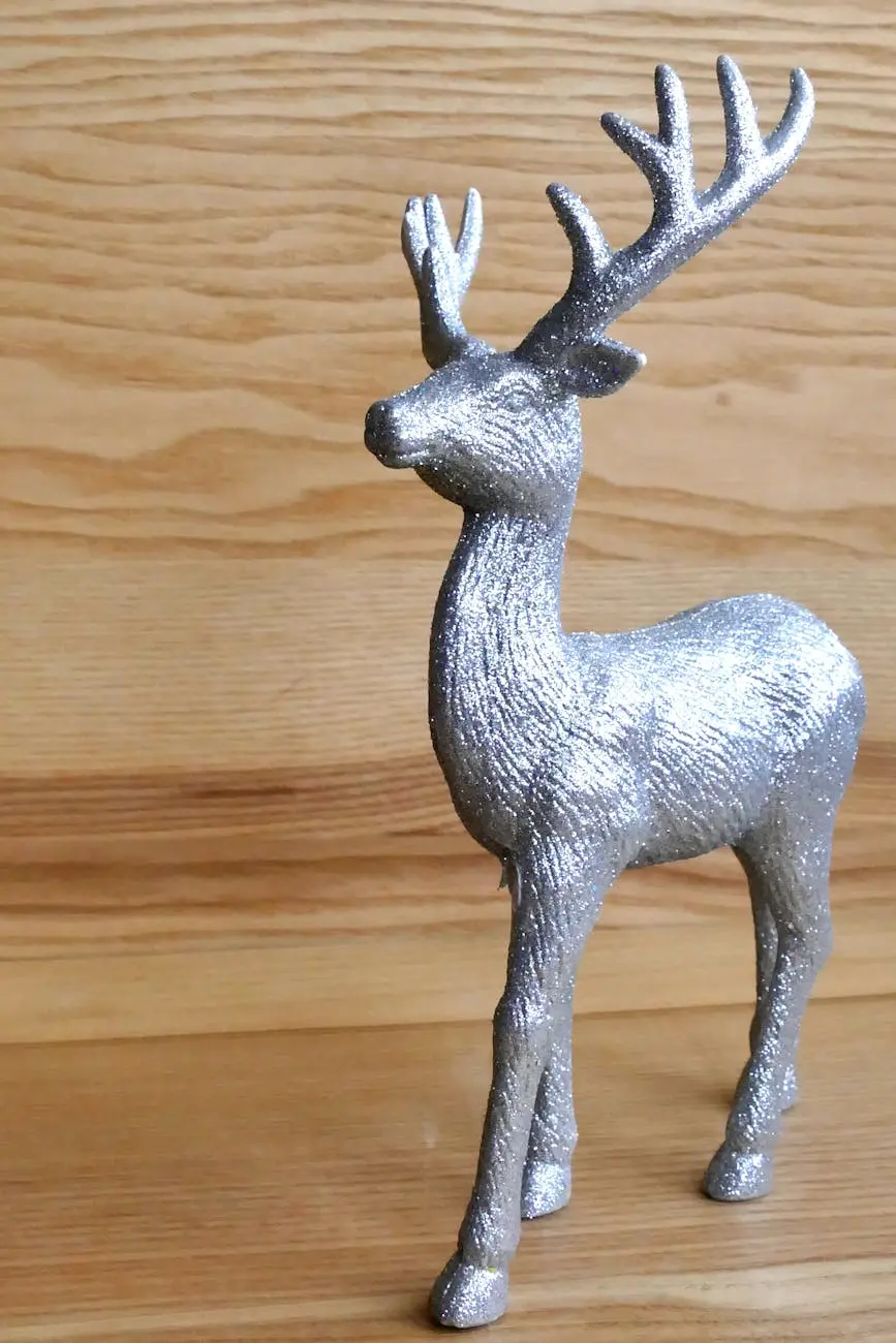 A glittery silver reindeer sculpture on a wooden surface, perfect for decor.