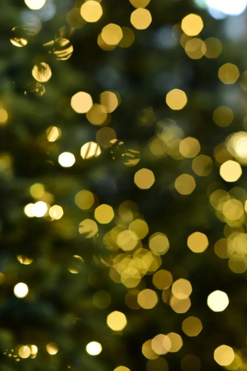 Golden bokeh lights creating a warm, festive holiday atmosphere. Perfect for seasonal designs.